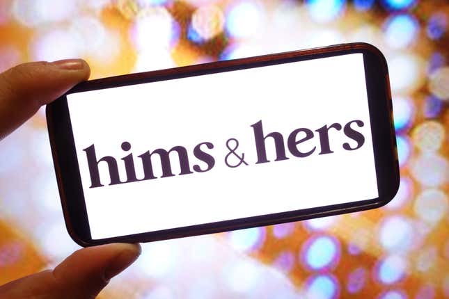 hand holding up a phone with the hims & hers logo in front of a colorful, light-speckled background